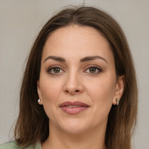 Joyful white young-adult female with medium  brown hair and green eyes