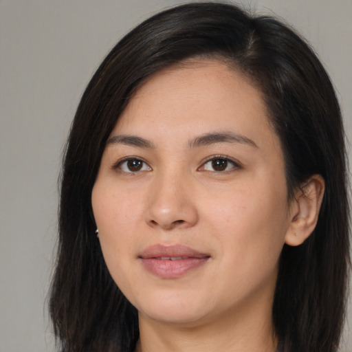 Joyful asian young-adult female with long  brown hair and brown eyes