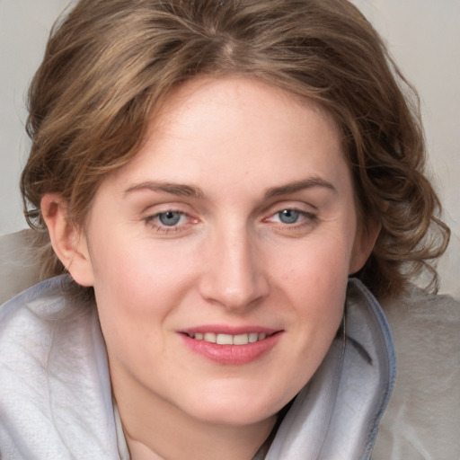 Joyful white young-adult female with medium  brown hair and blue eyes