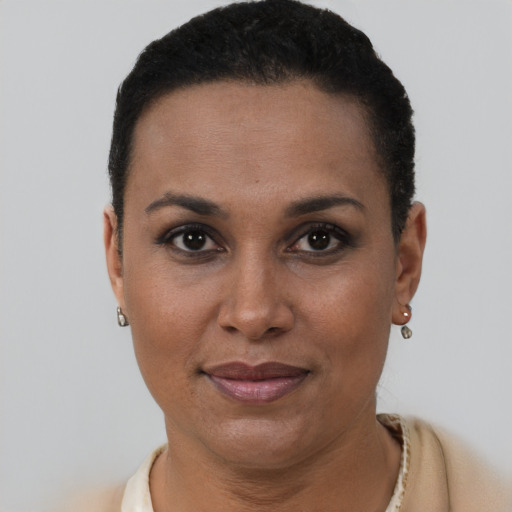 Joyful latino young-adult female with short  brown hair and brown eyes