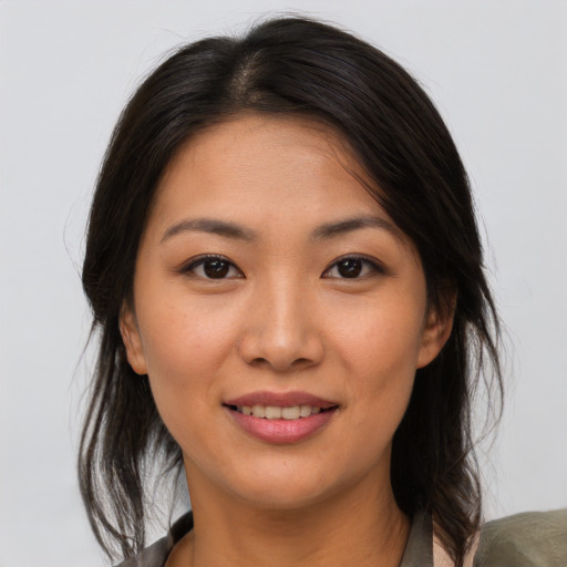 Joyful asian young-adult female with medium  brown hair and brown eyes