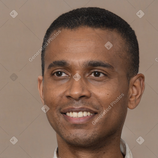 Joyful black young-adult male with short  black hair and brown eyes