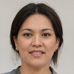 Joyful asian young-adult female with medium  brown hair and brown eyes