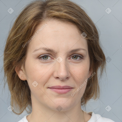 Joyful white adult female with medium  brown hair and blue eyes