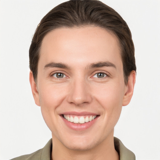 Joyful white young-adult male with short  brown hair and brown eyes