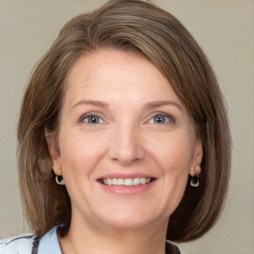 Joyful white adult female with medium  brown hair and grey eyes