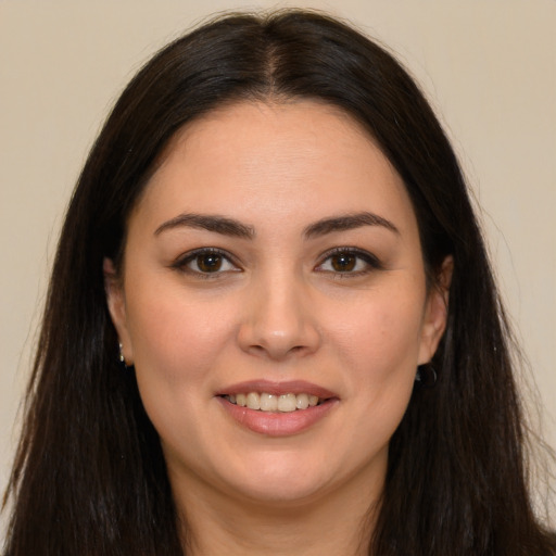 Joyful white young-adult female with long  brown hair and brown eyes