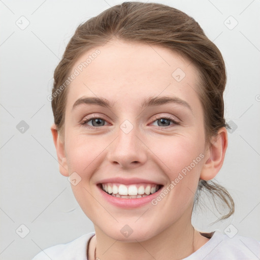 Joyful white young-adult female with medium  brown hair and blue eyes