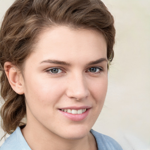 Joyful white young-adult female with medium  brown hair and blue eyes