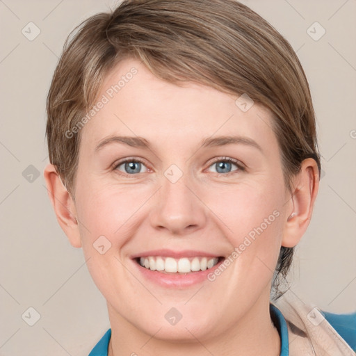 Joyful white young-adult female with short  brown hair and blue eyes