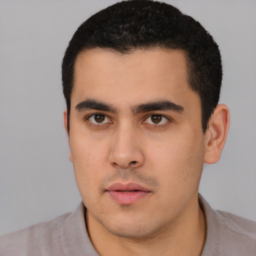 Neutral latino young-adult male with short  black hair and brown eyes