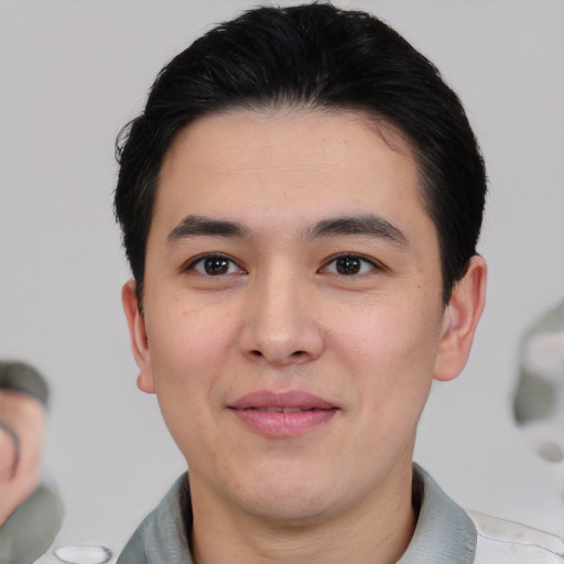 Joyful asian young-adult male with short  black hair and brown eyes