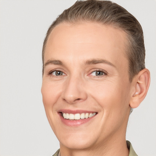 Joyful white adult female with short  brown hair and brown eyes