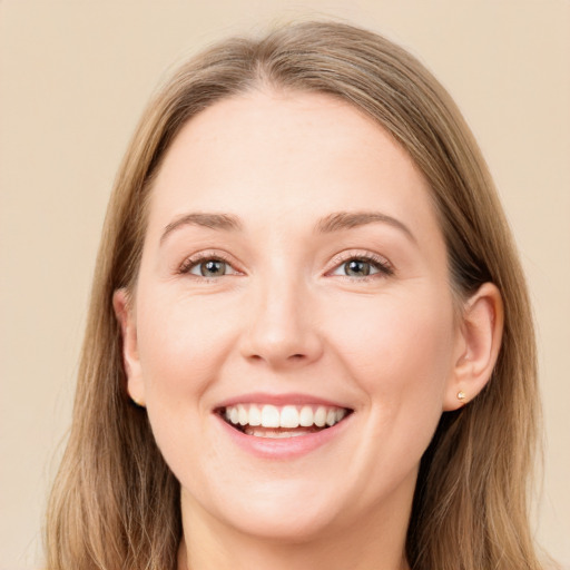 Joyful white young-adult female with long  brown hair and blue eyes