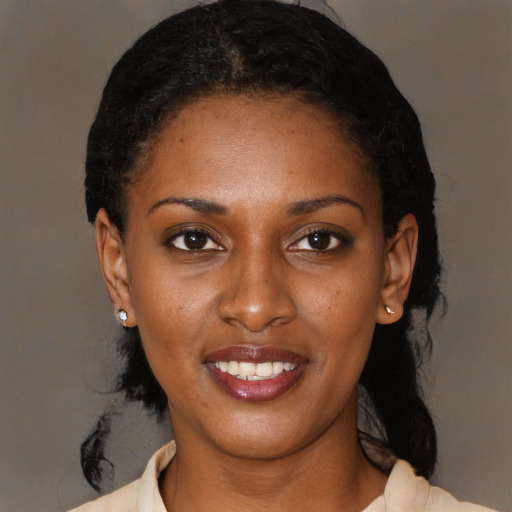 Joyful black young-adult female with medium  black hair and brown eyes