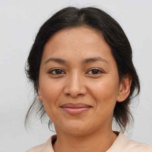 Joyful latino young-adult female with medium  brown hair and brown eyes