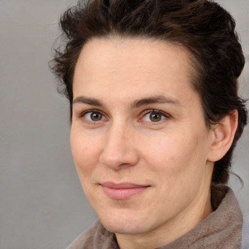 Joyful white adult female with medium  brown hair and brown eyes