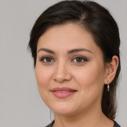 Joyful white young-adult female with medium  brown hair and brown eyes