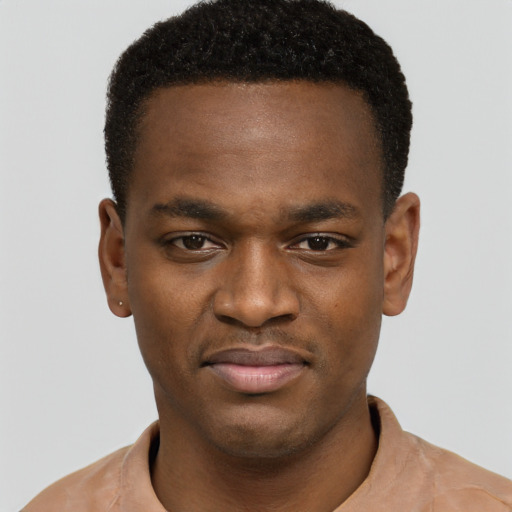 Joyful black young-adult male with short  brown hair and brown eyes