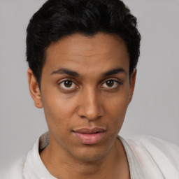 Joyful latino young-adult male with short  brown hair and brown eyes