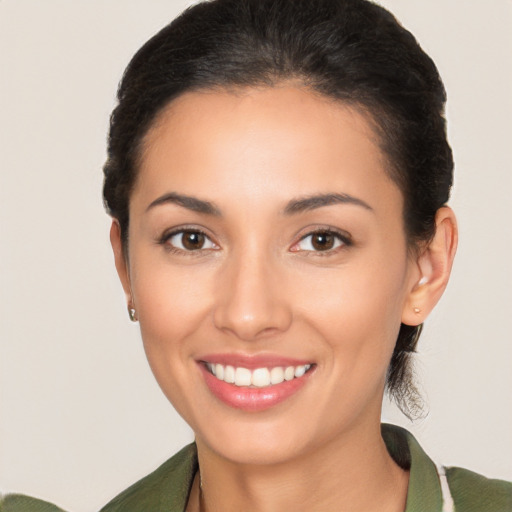 Joyful latino young-adult female with medium  brown hair and brown eyes