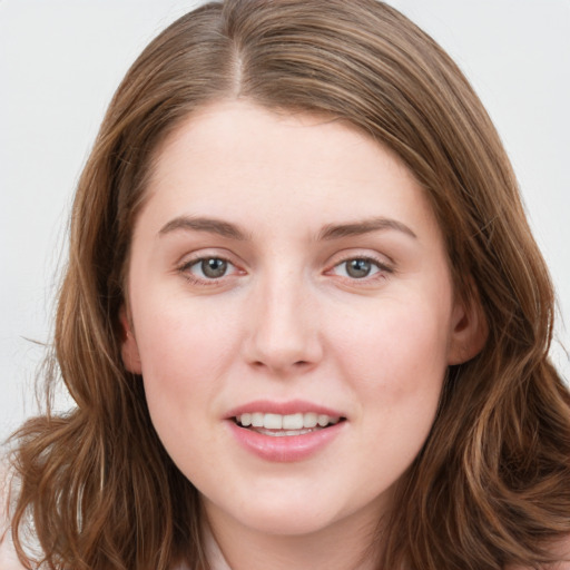 Joyful white young-adult female with long  brown hair and blue eyes