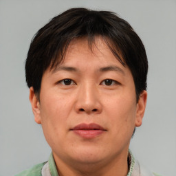 Joyful asian adult female with short  brown hair and brown eyes