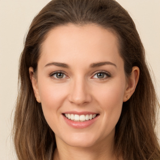 Joyful white young-adult female with long  brown hair and brown eyes