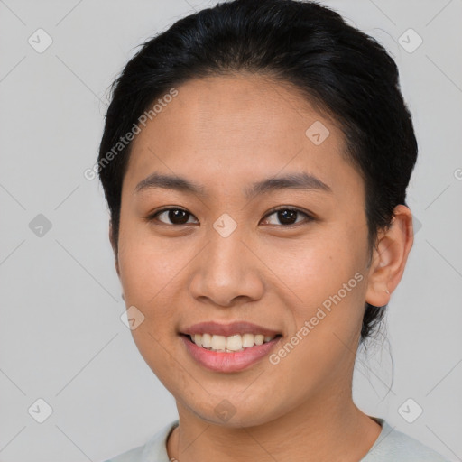 Joyful asian young-adult female with short  brown hair and brown eyes