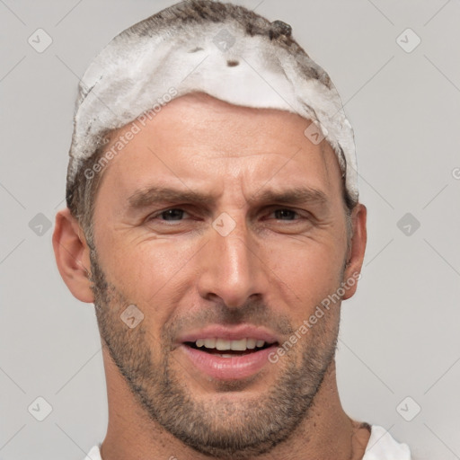 Joyful white adult male with short  brown hair and brown eyes