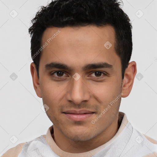 Joyful latino young-adult male with short  brown hair and brown eyes