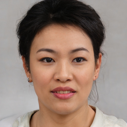 Joyful asian young-adult female with medium  brown hair and brown eyes