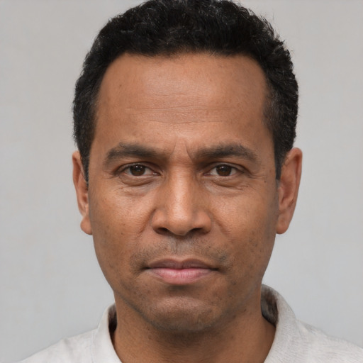 Neutral latino adult male with short  black hair and brown eyes