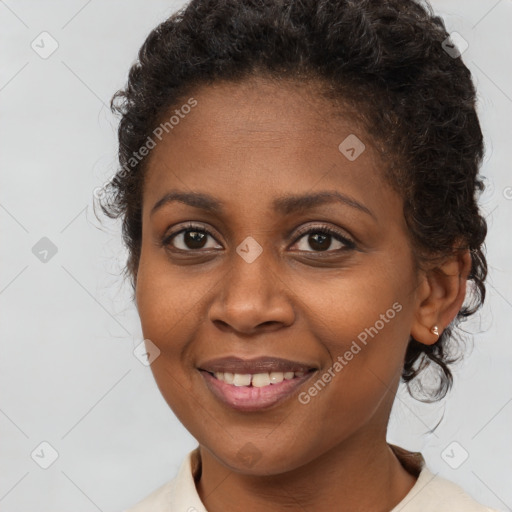 Joyful black young-adult female with long  brown hair and brown eyes