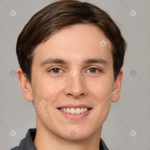 Joyful white young-adult male with short  brown hair and grey eyes