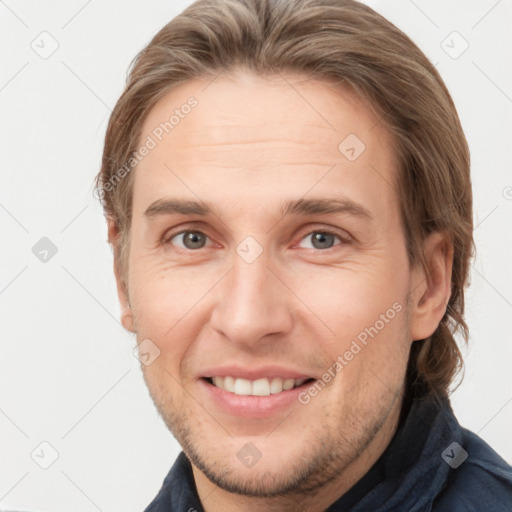 Joyful white adult male with short  brown hair and grey eyes