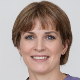 Joyful white adult female with medium  brown hair and grey eyes