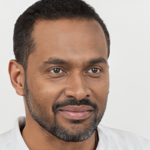 Joyful black young-adult male with short  brown hair and brown eyes