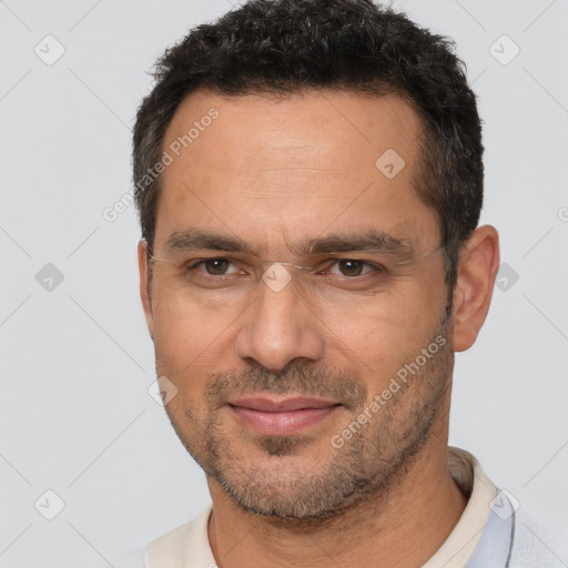 Joyful white adult male with short  brown hair and brown eyes