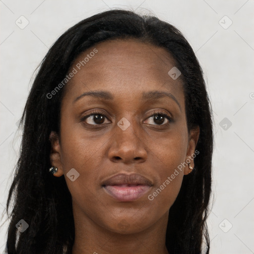 Joyful black young-adult female with long  brown hair and brown eyes