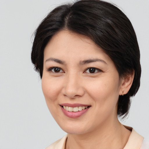 Joyful asian young-adult female with medium  brown hair and brown eyes