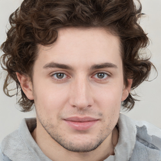 Joyful white young-adult male with medium  brown hair and brown eyes