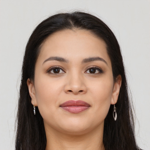 Joyful latino young-adult female with long  brown hair and brown eyes