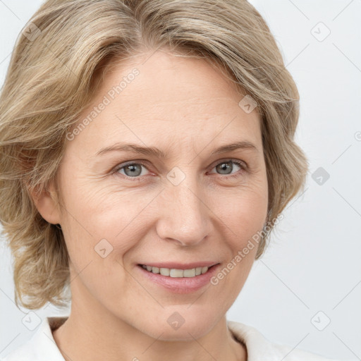 Joyful white adult female with medium  brown hair and blue eyes