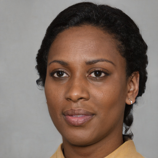 Joyful black young-adult female with medium  black hair and brown eyes