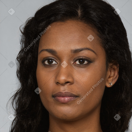 Joyful black young-adult female with long  brown hair and brown eyes