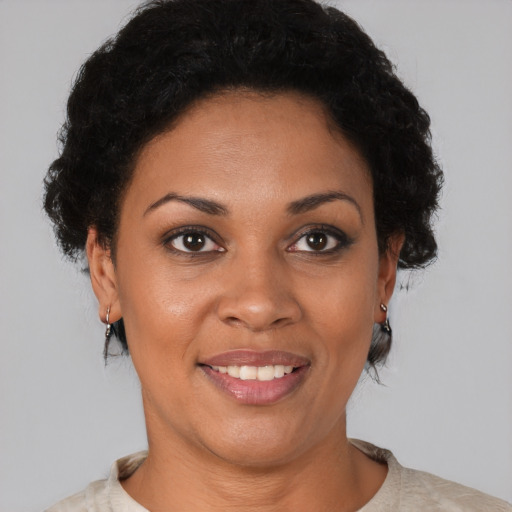 Joyful black young-adult female with short  brown hair and brown eyes