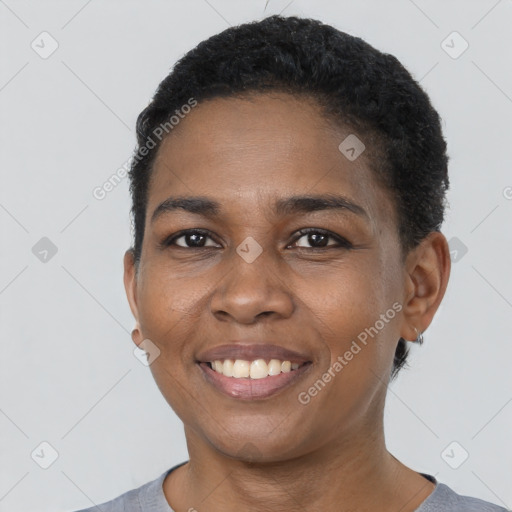 Joyful black young-adult female with short  black hair and brown eyes