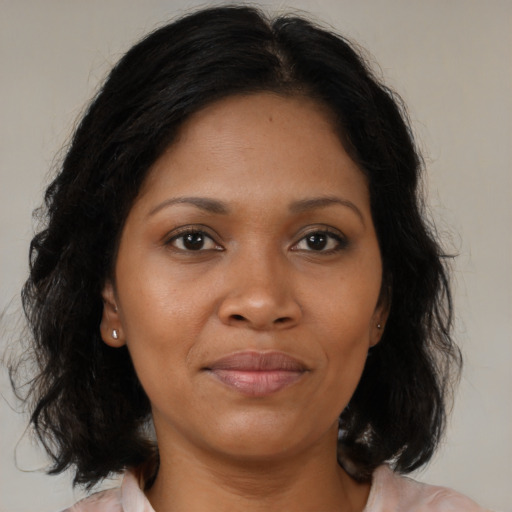 Joyful black young-adult female with medium  brown hair and brown eyes