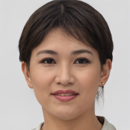 Joyful asian young-adult female with short  brown hair and brown eyes